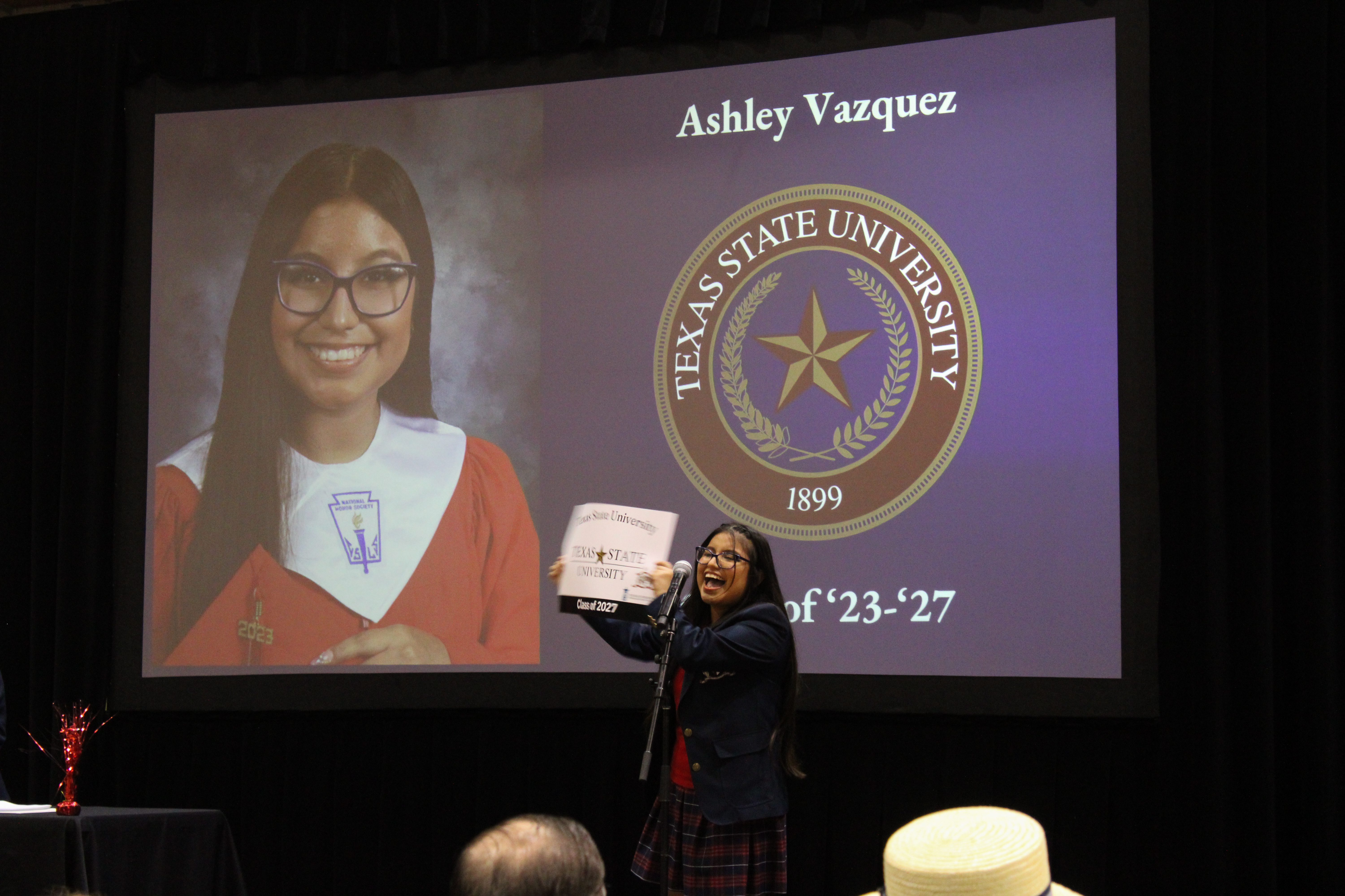 Picture of Ashley Vazquez holding a Texas State poster announcing where she is attending